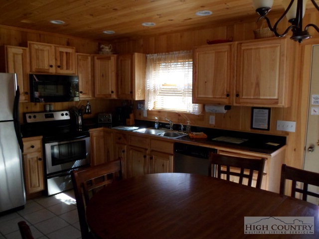 279 Indian Springs Road Boone, NC 28607 - Photo 11 of 15 a kitchen with a stove a sink and a microwave