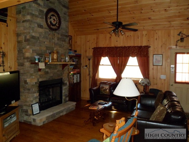 279 Indian Springs Road Boone, NC 28607 - Photo 9 of 15 a living room with furniture a fireplace and a window