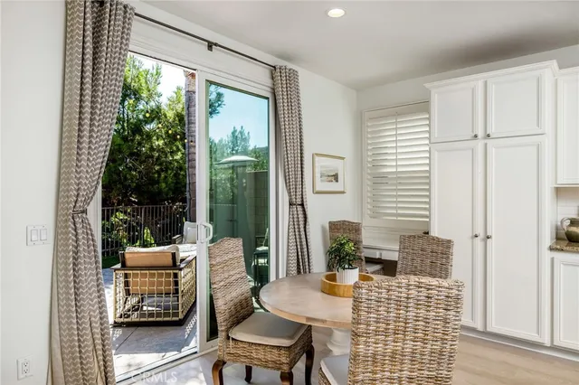 a view of a patio with couches table and chairs and potted plants