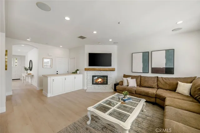 a living room with furniture fireplace and flat screen tv