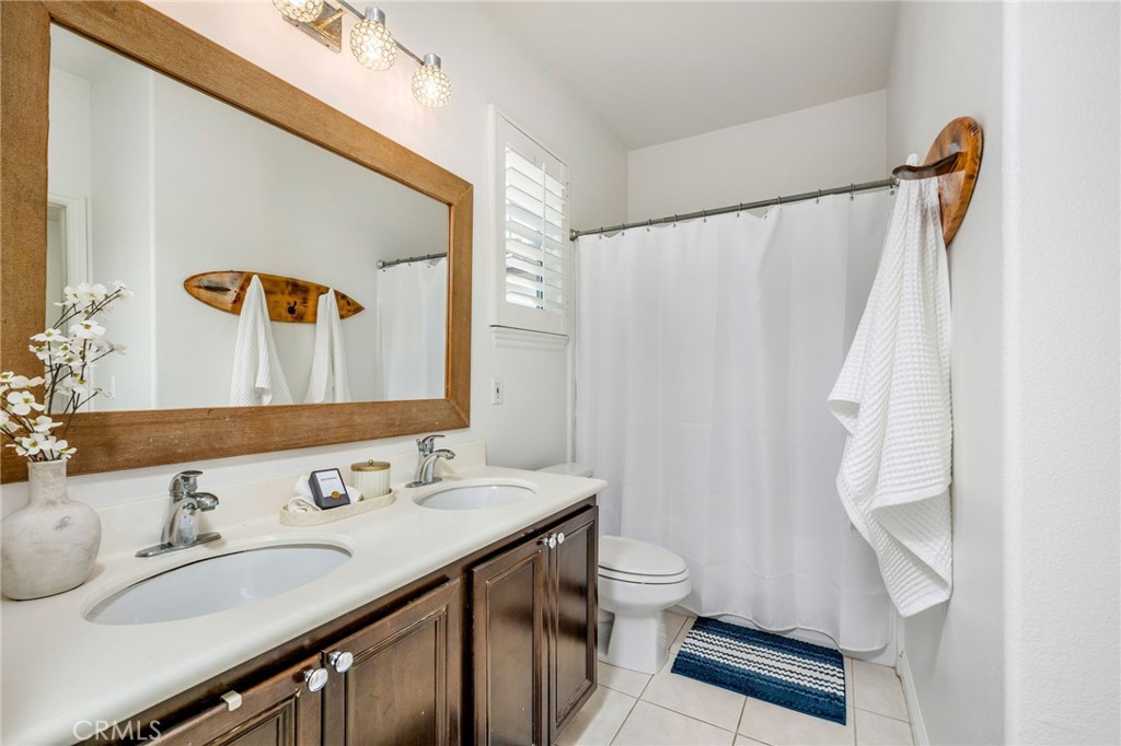 1204 Vista Jardin San Clemente, CA 92673 - Photo 38 of 55 a bathroom with a granite countertop sink toilet and shower