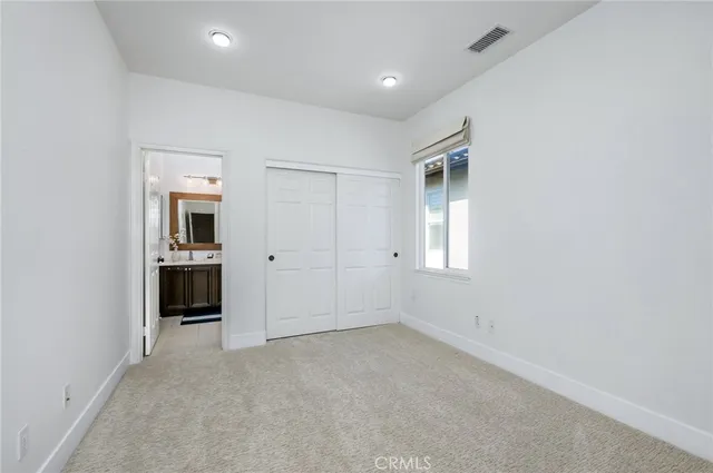 a bathroom with a sink vanity mirror and toilet