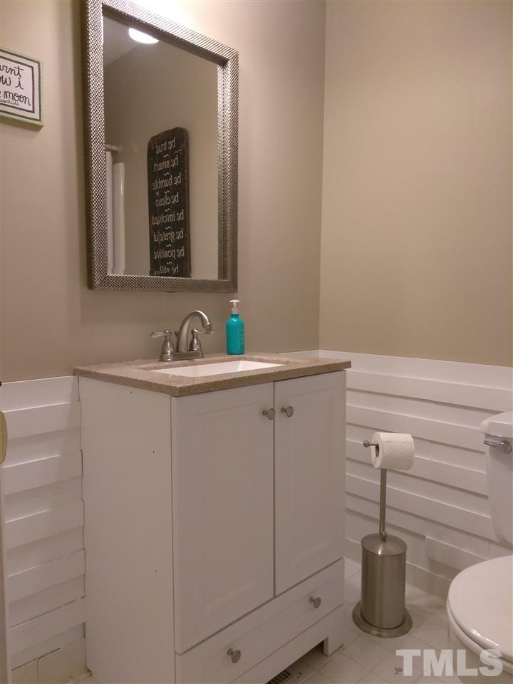 4101 Amherst Lane Raleigh, NC 27609 - Photo 13 of 17 a bathroom with a sink and a mirror