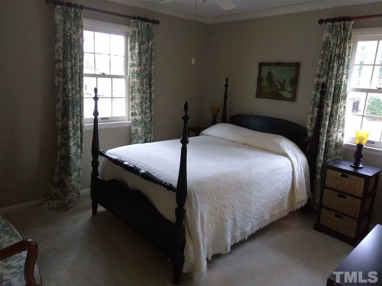 4101 Amherst Lane Raleigh, NC 27609 - Photo 14 of 17 a bedroom with a bed and a window