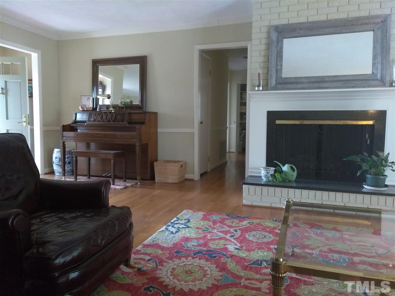4101 Amherst Lane Raleigh, NC 27609 - Photo 7 of 17 a living room with furniture and a fireplace