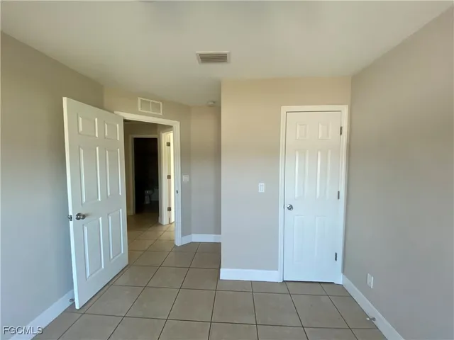 a view of an empty room and closet area
