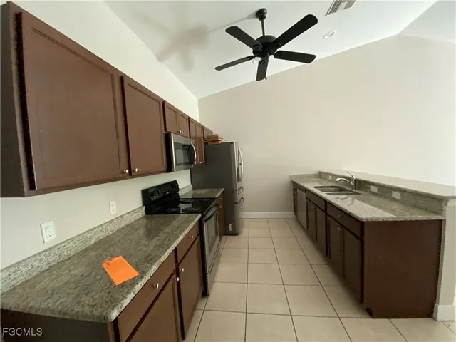 a kitchen with stainless steel appliances granite countertop a stove and a sink
