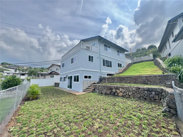 a large tree in front of a house