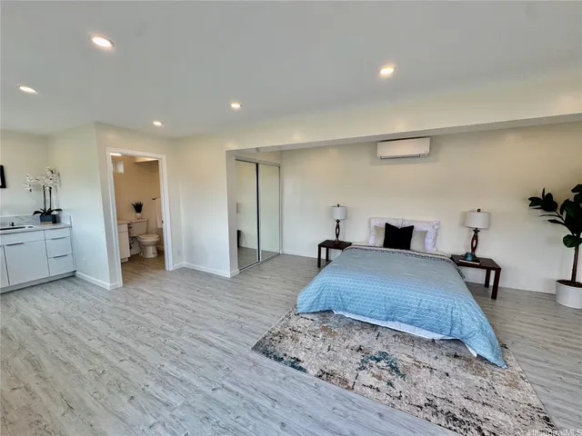 a spacious bedroom with a bed and a table