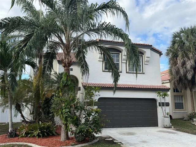 a kitchen with kitchen island a counter top space cabinets and stainless steel appliances