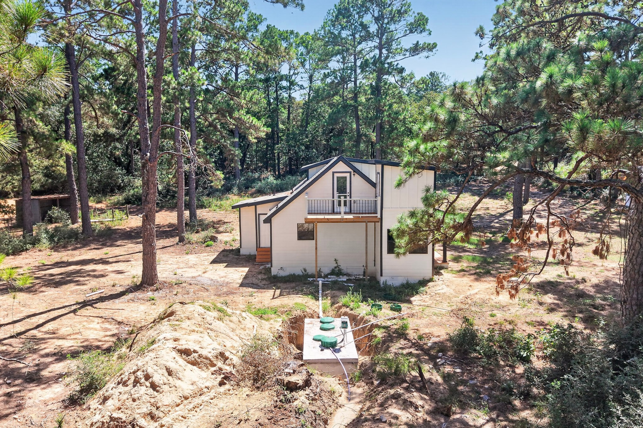 158 Fealy Road Red Rock, TX 78662 - Photo 39 of 40 Towering pines surround a secluded multi-level home with a private upper balcony.
