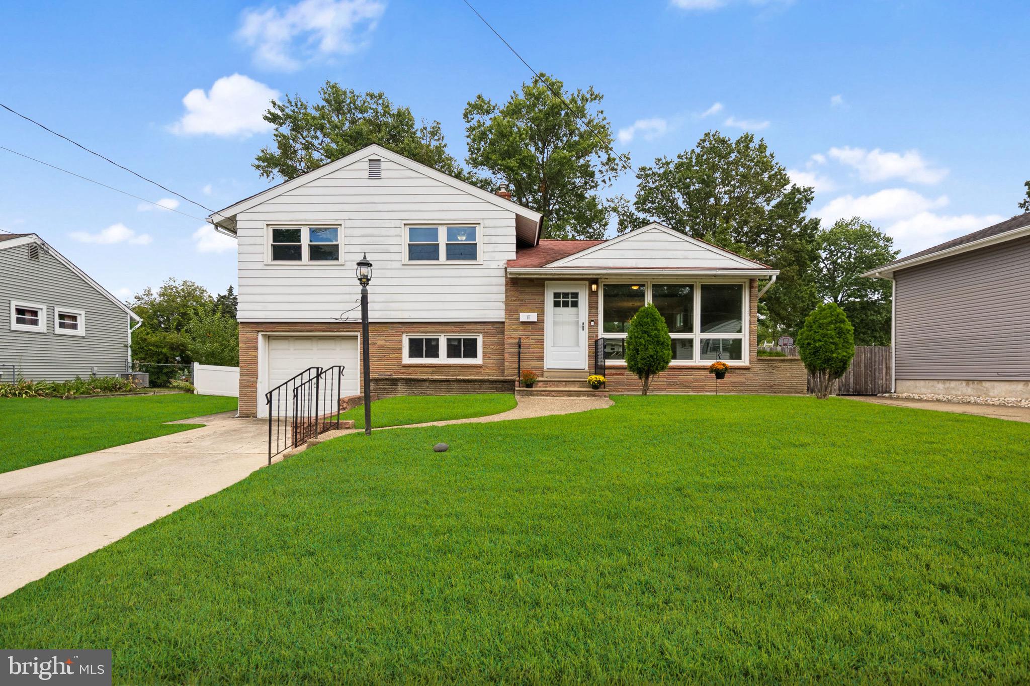 a front view of a house with a yard table and chairs
