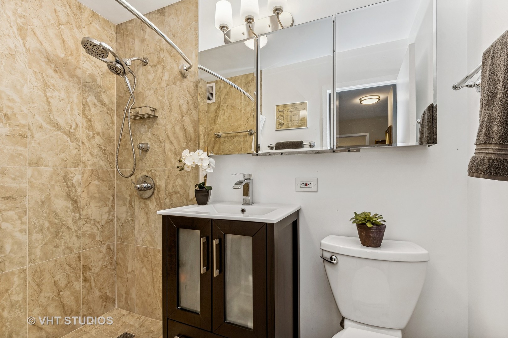 555 West Cornelia Avenue, Unit 412 Chicago, IL 60657 - Photo 9 of 20 a bathroom with a sink a toilet and mirror