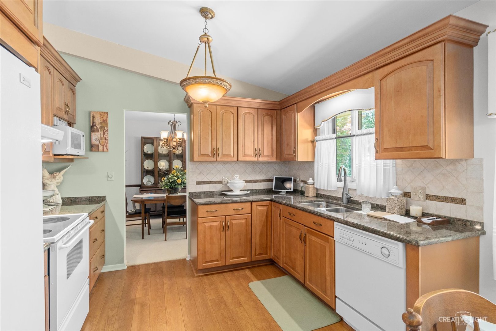 527 Sheffield Road Naperville, IL 60565 - Photo 9 of 27 a kitchen with granite countertop a sink stainless steel appliances and cabinets
