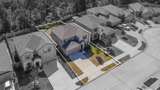an aerial view of a house with a garden