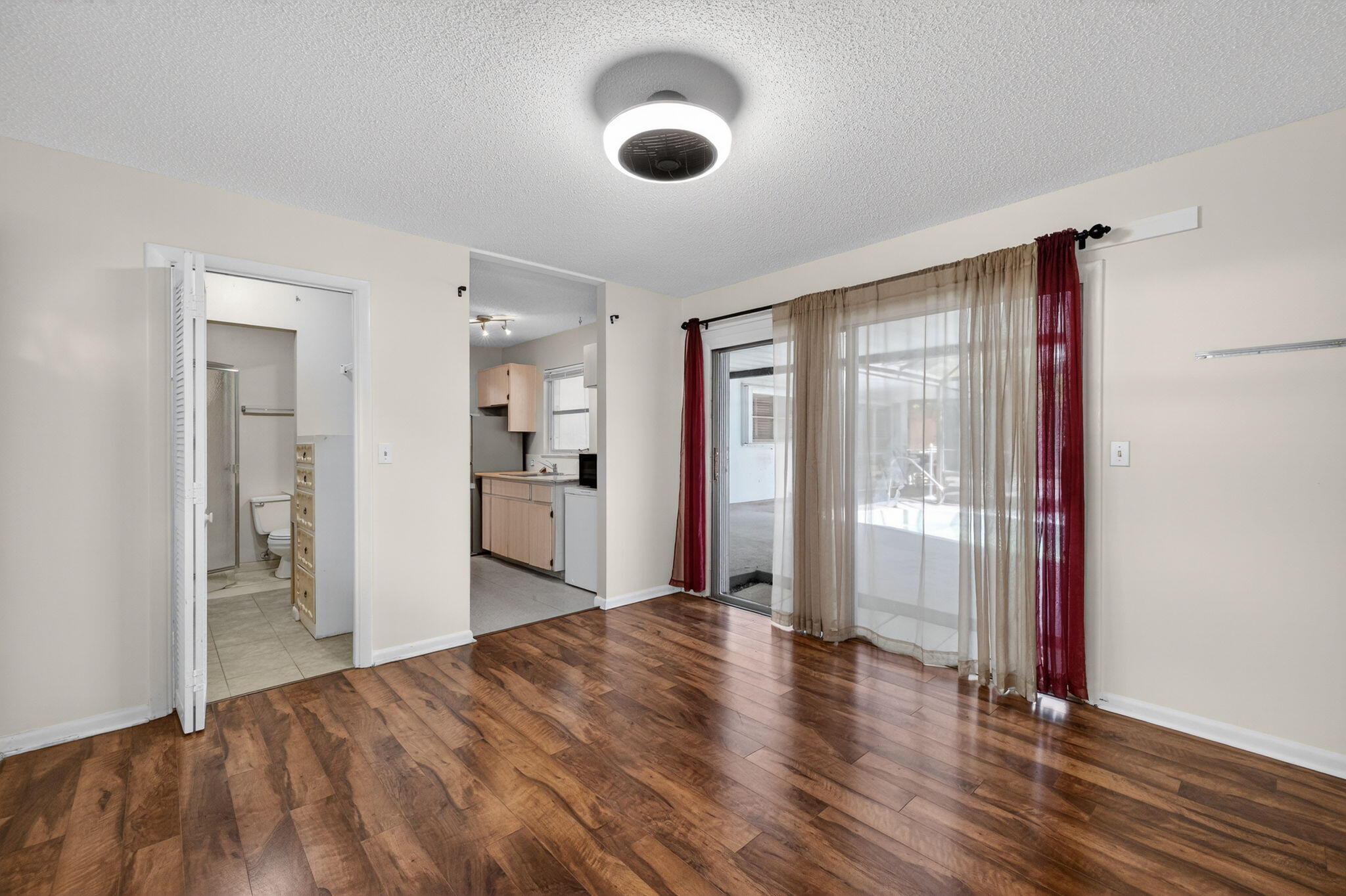 1040 Southeast 5th Street Stuart, FL 34996 - Photo 12 of 21 a view of a room with wooden floor and windows