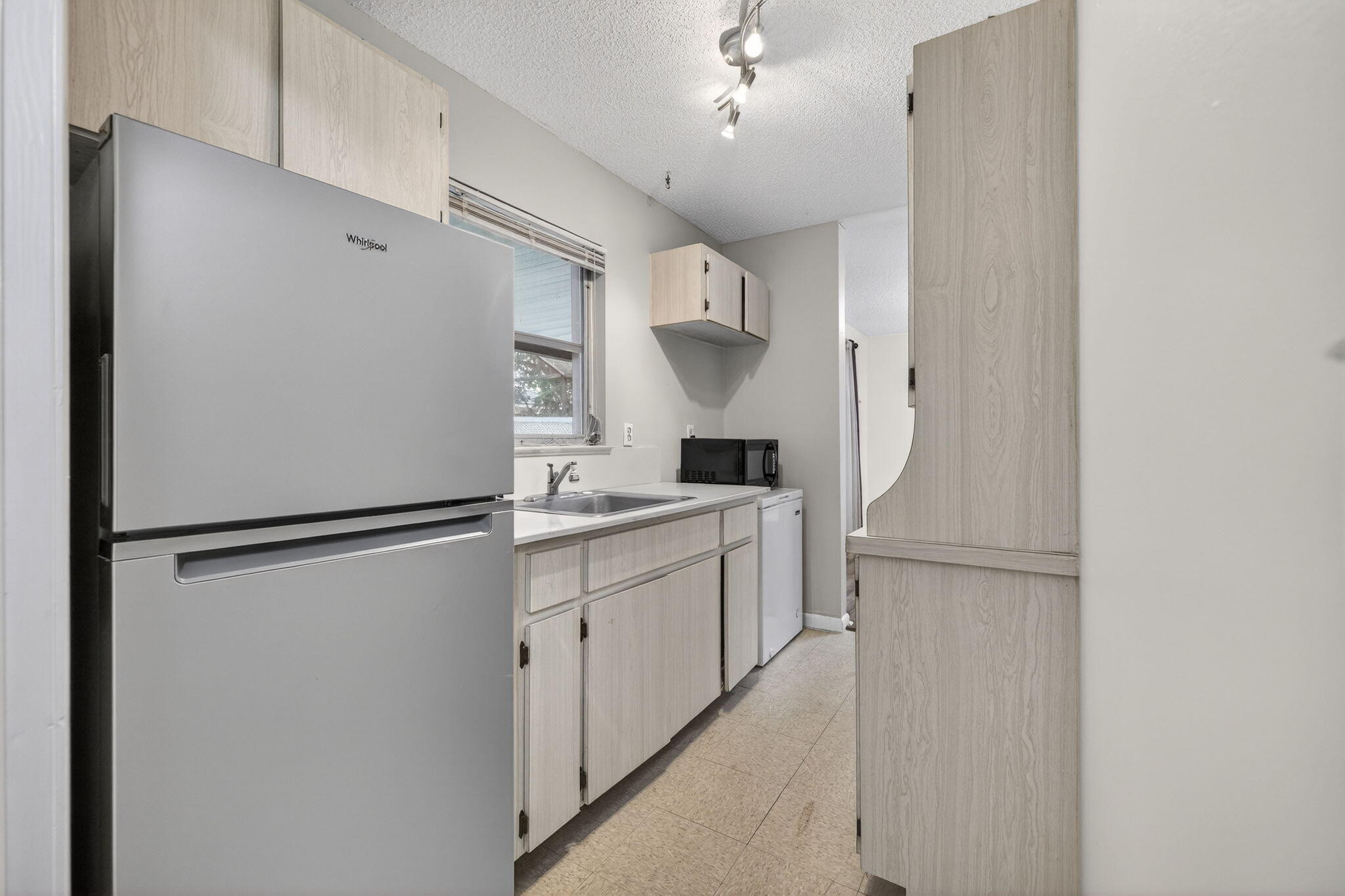 1040 Southeast 5th Street Stuart, FL 34996 - Photo 15 of 21 a kitchen with a refrigerator a sink and dishwasher