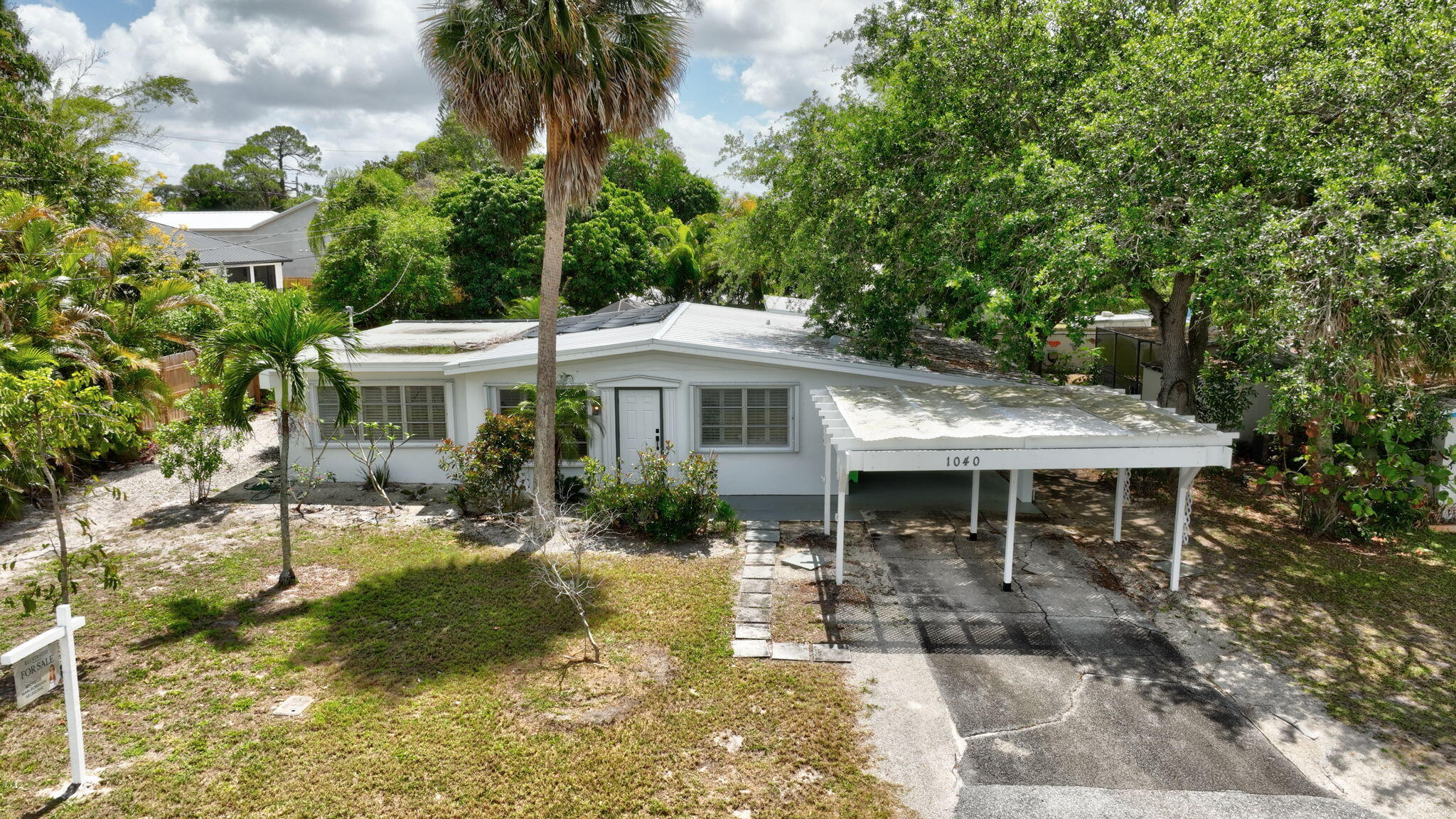 1040 Southeast 5th Street Stuart, FL 34996 - Photo 18 of 21 a front view of a house with garden