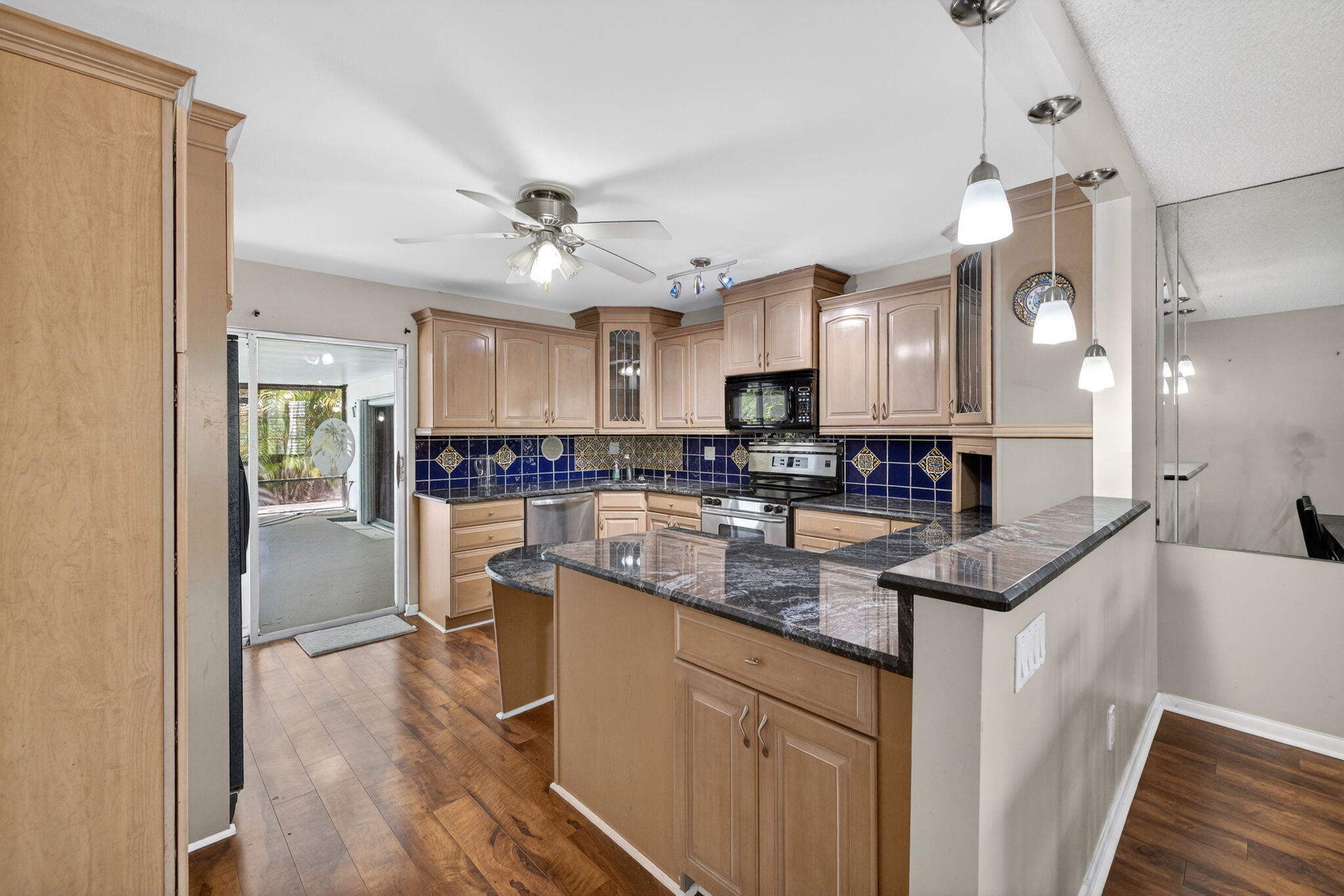 1040 Southeast 5th Street Stuart, FL 34996 - Photo 5 of 21 a kitchen with stainless steel appliances granite countertop a refrigerator a sink dishwasher a stove and white countertops with wooden floor