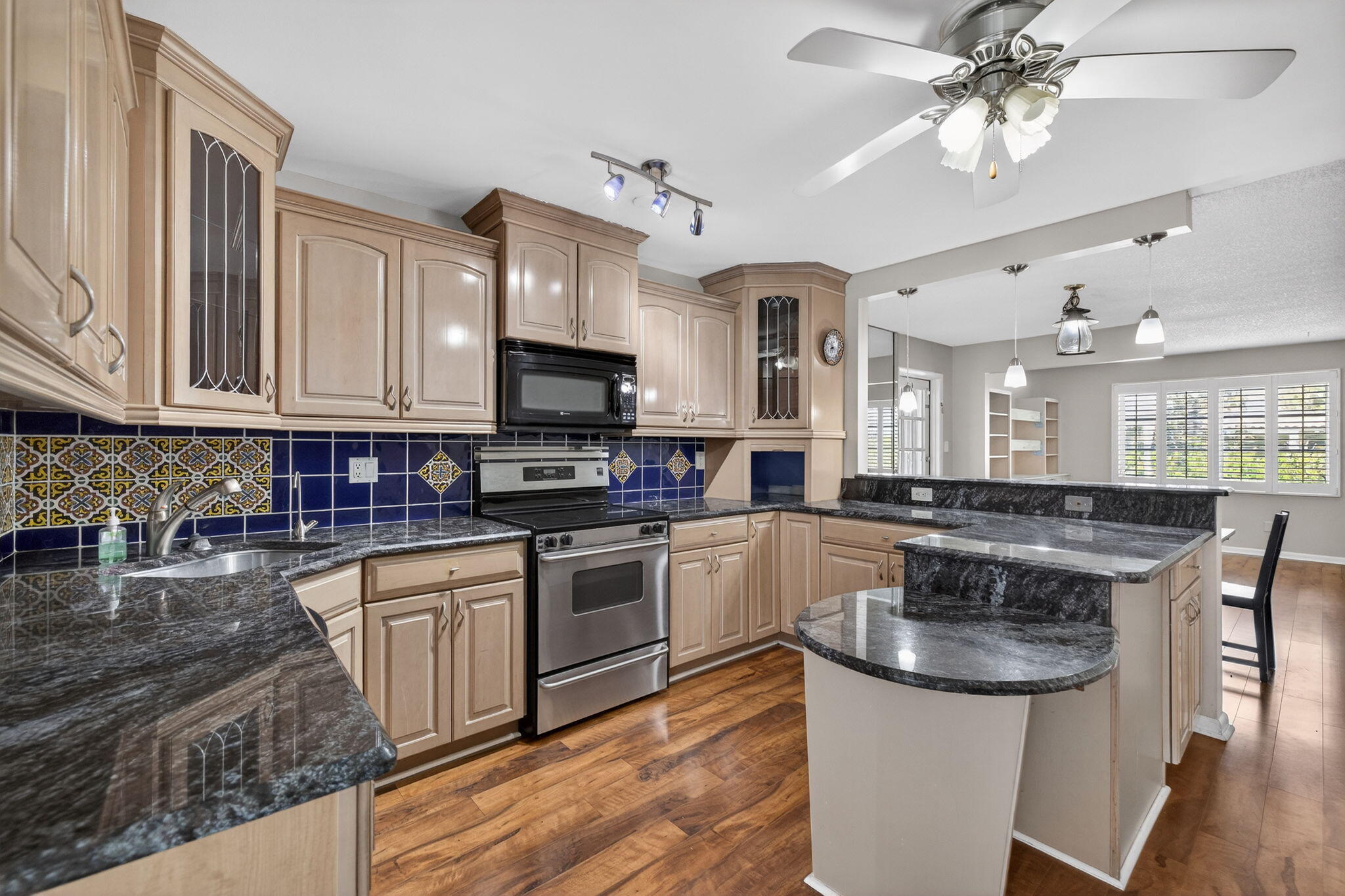 1040 Southeast 5th Street Stuart, FL 34996 - Photo 6 of 21 a kitchen with stainless steel appliances granite countertop a sink stove and refrigerator