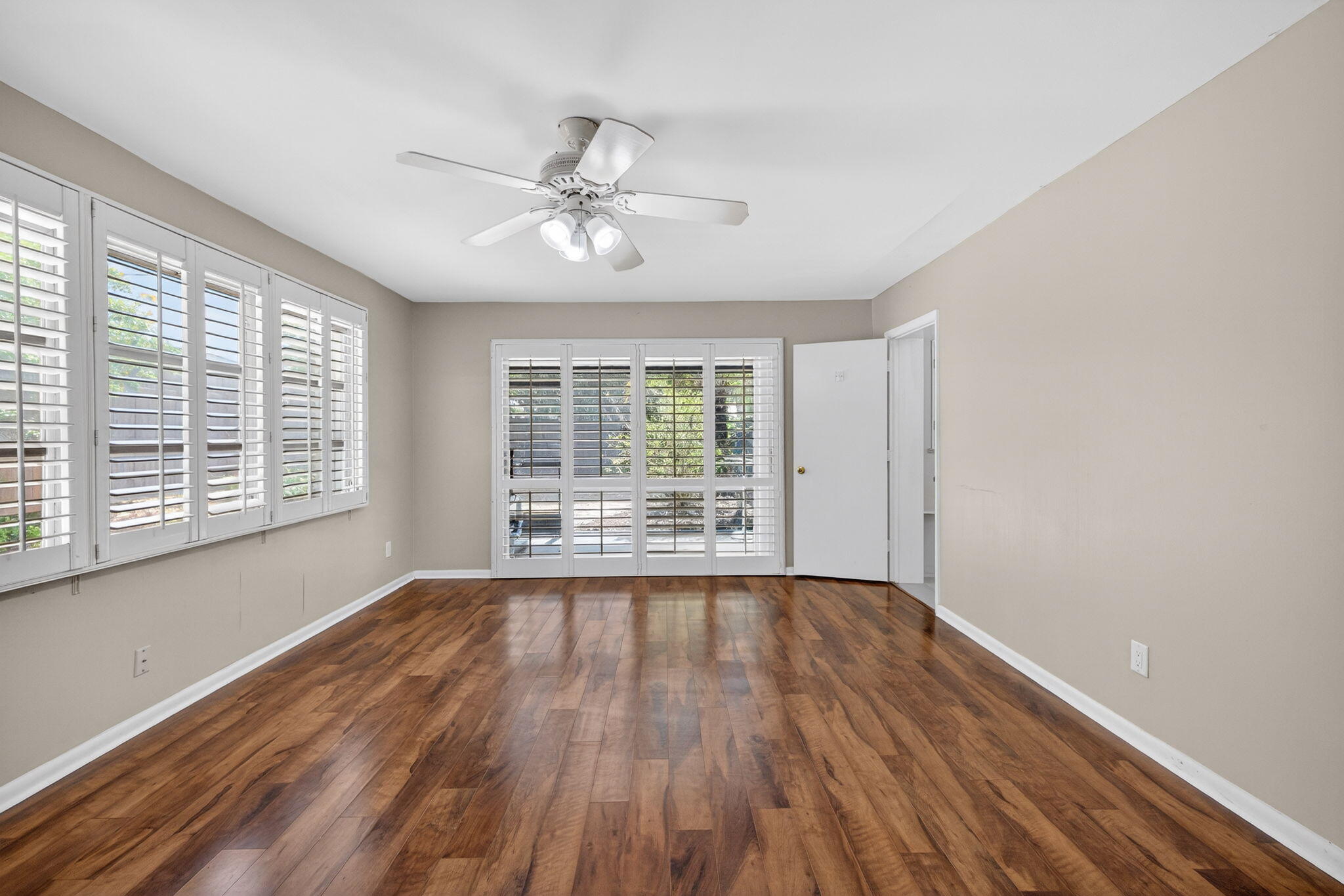 1040 Southeast 5th Street Stuart, FL 34996 - Photo 9 of 21 a view of an empty room with wooden floor and a window