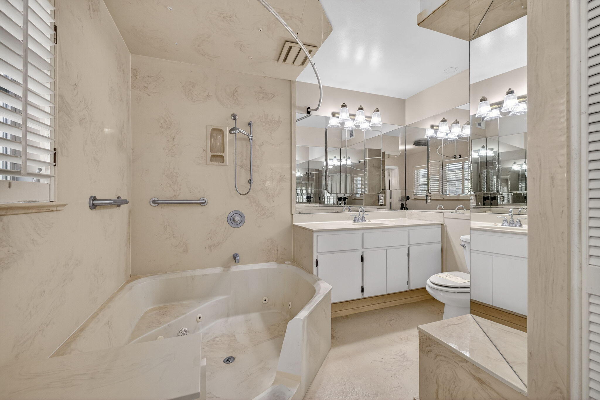 1040 Southeast 5th Street Stuart, FL 34996 - Photo 10 of 21 a bathroom with a sink a toilet a mirror and shower