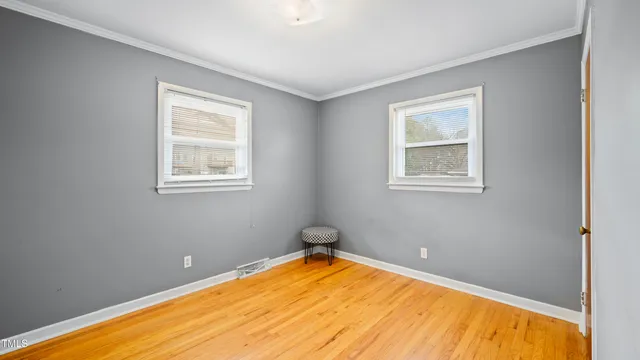 a view of a room with a wooden floor and a window