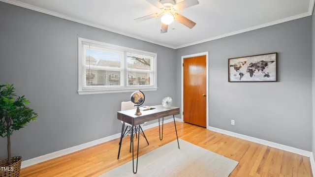 a workspace with wooden floor and a potted plant