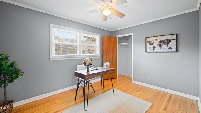 a view of a workspace with furniture and a window