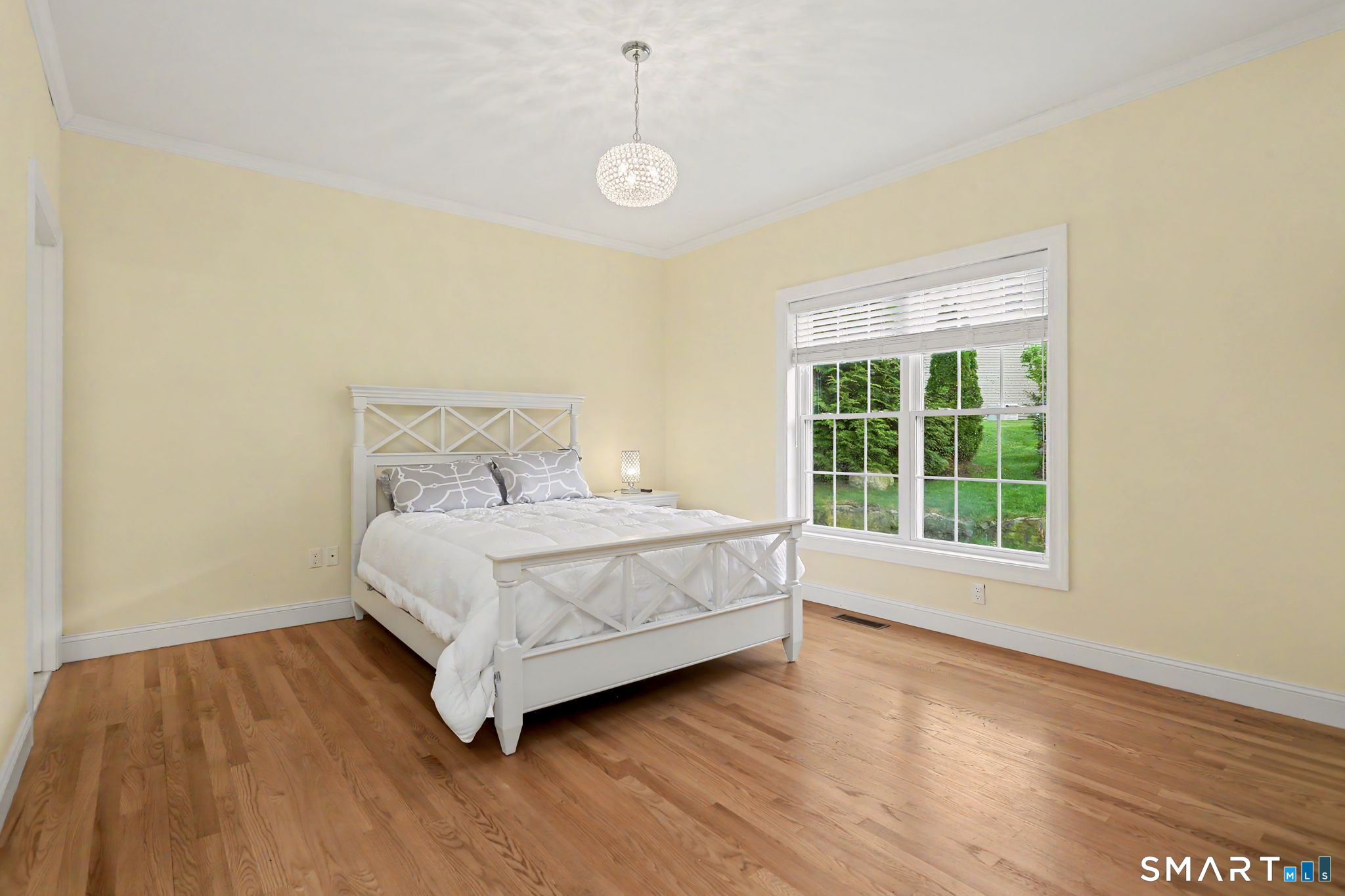 223 Meadow Brook Road, Unit 223 Oxford, CT 06478 - Photo 15 of 34 a bedroom with a bed and wooden floor