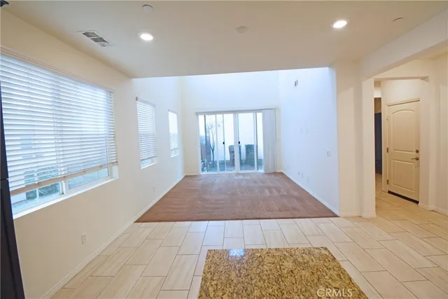 a view of hallway with a rug and a window