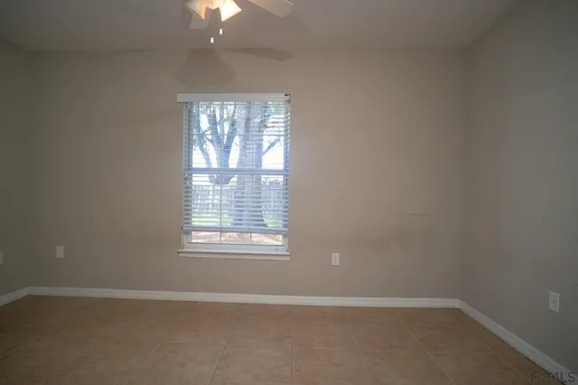an empty room with a empty room and chandelier fan