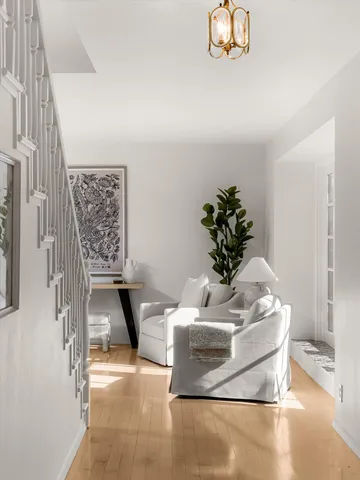 a living room with furniture a fireplace and a large window