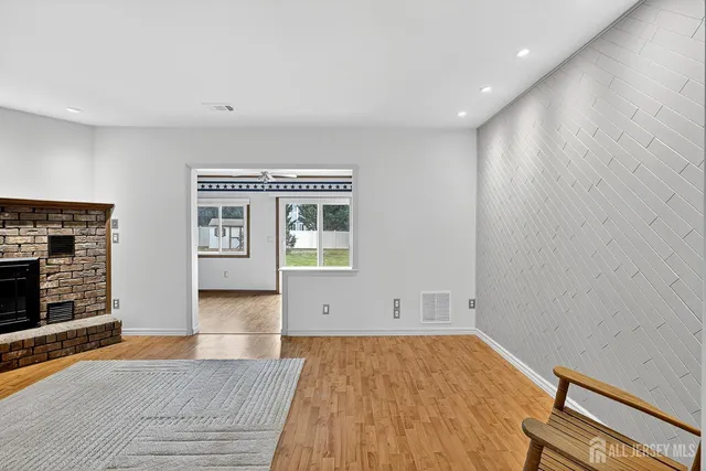 wooden floor in an empty room with a fireplace