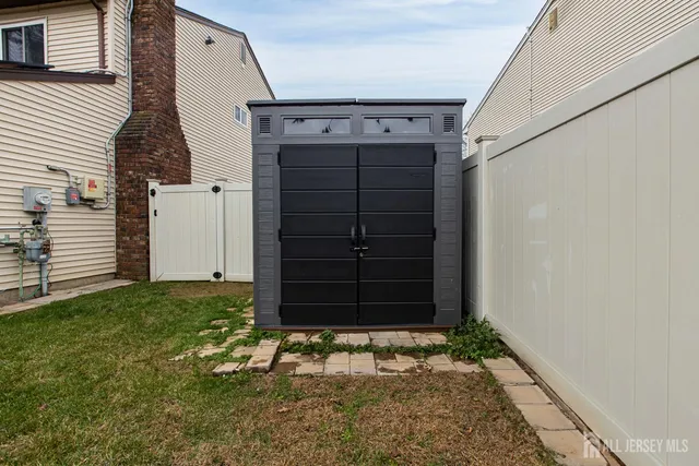 a white house that has tree in front of it