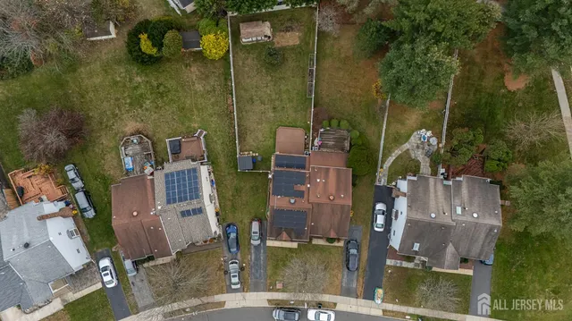 a front view of a house with a garden and trees