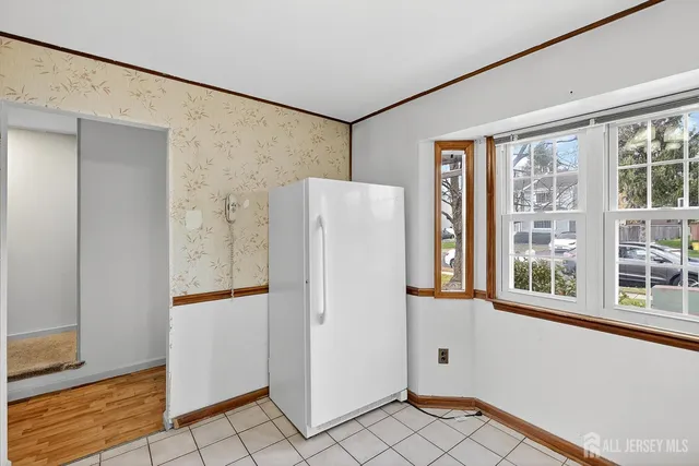 a white refrigerator freezer and a window in a room