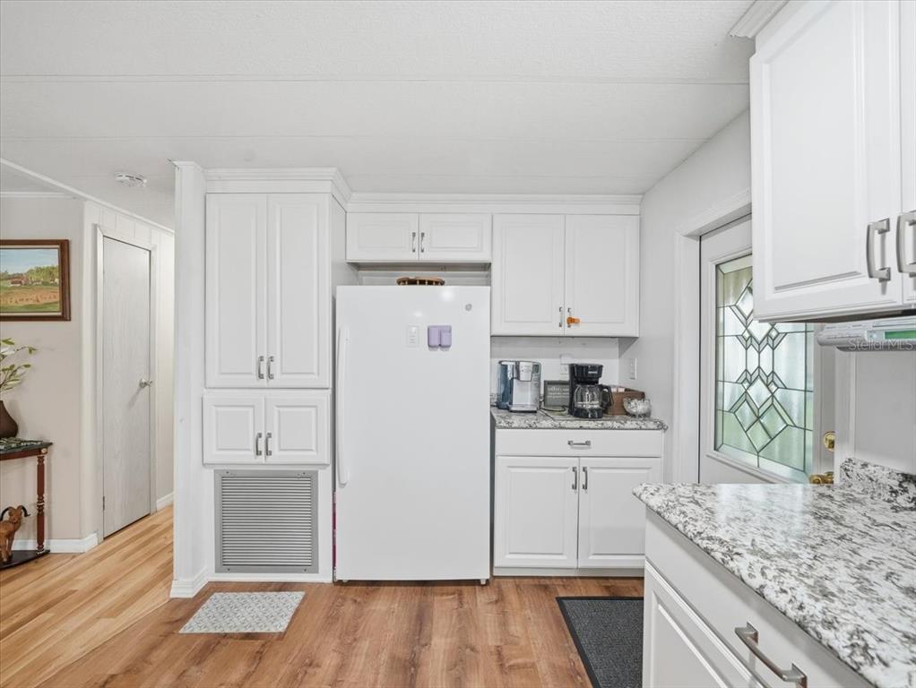 1422 North Reed Terrace Inverness, FL 34453 - Photo 14 of 39 a kitchen with granite countertop a sink stove and refrigerator