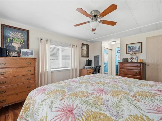 a bedroom with a large bed and a dresser