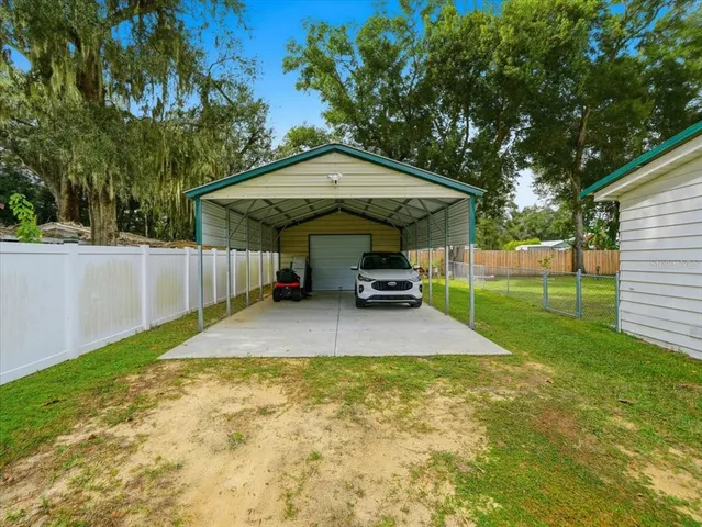 a backyard of a house with table and chairs