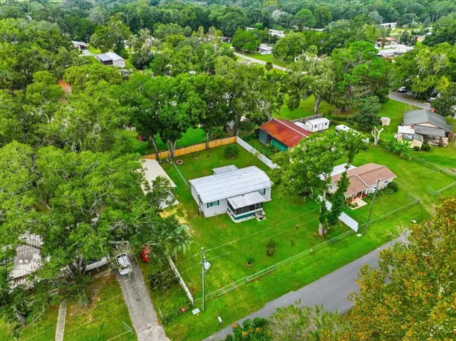an aerial view of a house with a yard