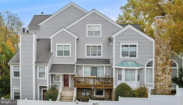 a view of a white house with large windows