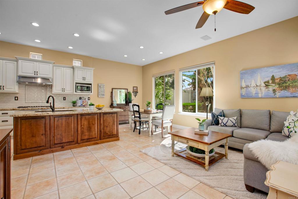 7159 Tanager Drive Carlsbad, CA 92011 - Photo 21 of 68 a living room with furniture a dining table and kitchen view