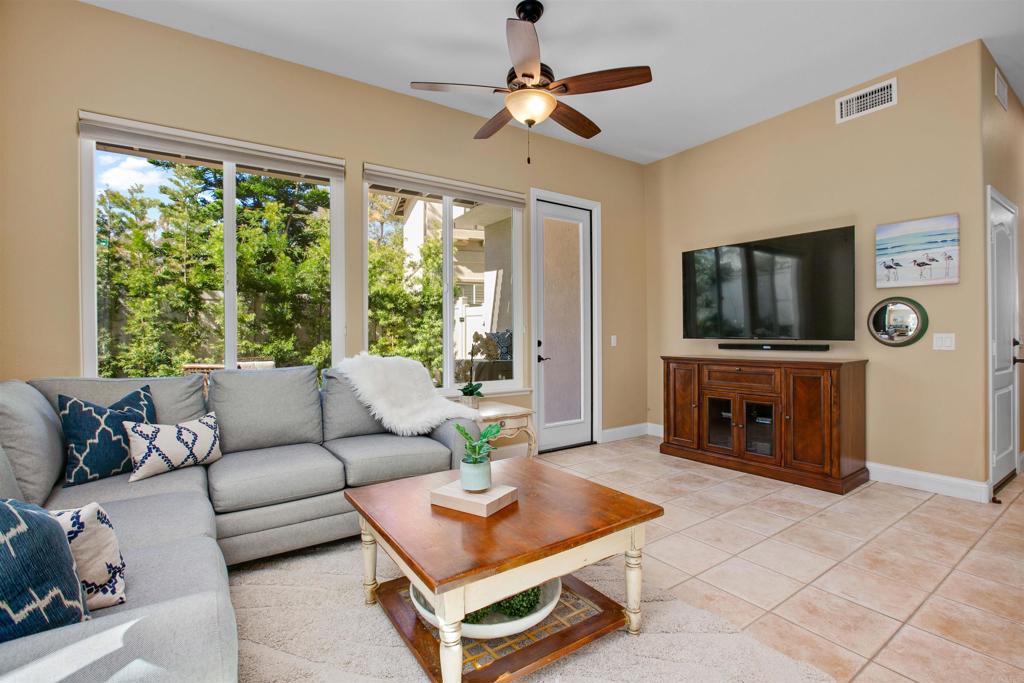 7159 Tanager Drive Carlsbad, CA 92011 - Photo 23 of 68 a living room with furniture a flat screen tv and a large window