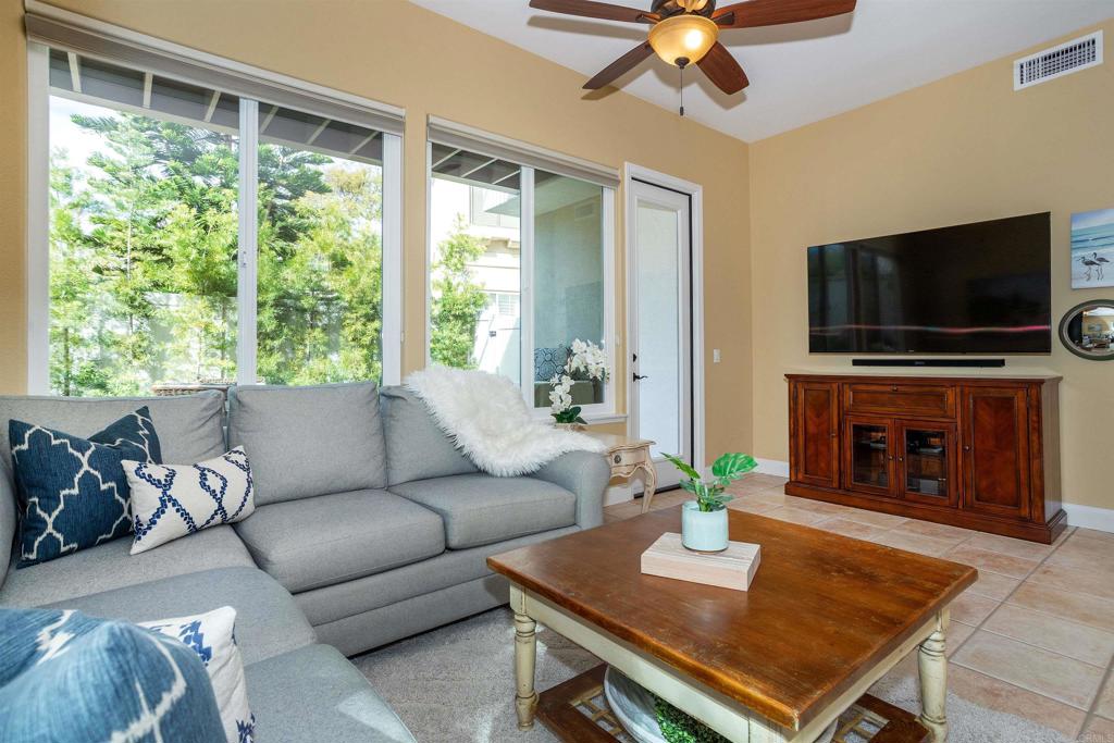 7159 Tanager Drive Carlsbad, CA 92011 - Photo 24 of 68 a living room with furniture a fireplace and a flat screen tv