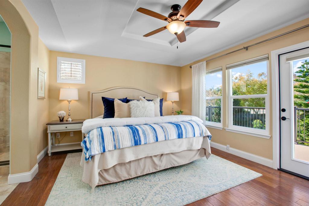 7159 Tanager Drive Carlsbad, CA 92011 - Photo 34 of 68 a bedroom with a large bed and a chandelier