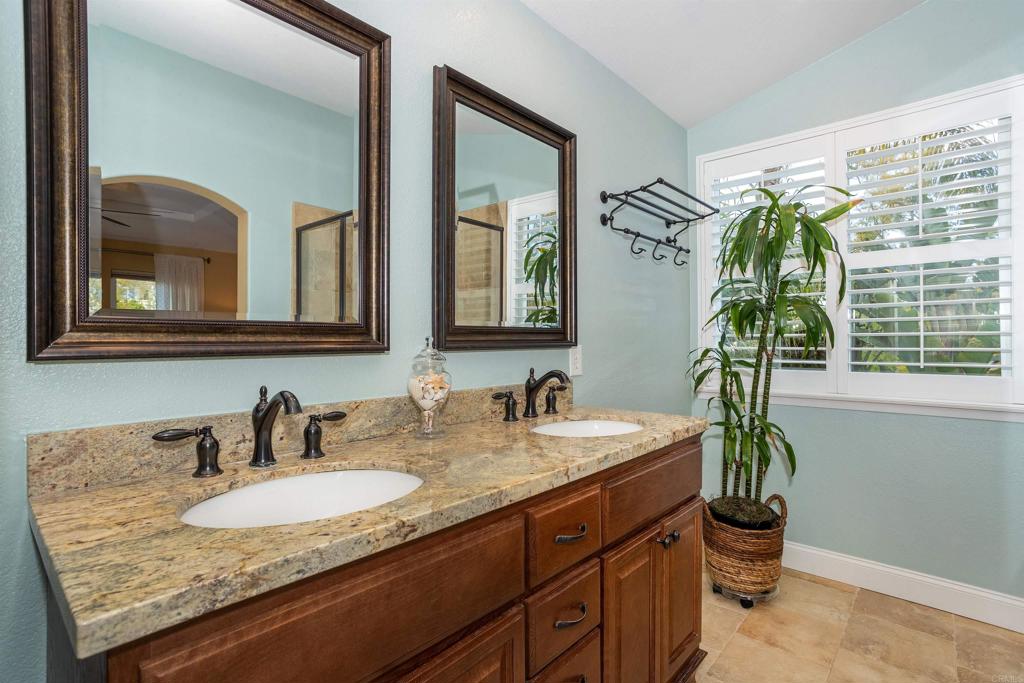 7159 Tanager Drive Carlsbad, CA 92011 - Photo 36 of 68 a bathroom with a granite countertop sink and a mirror
