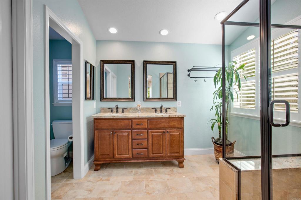 7159 Tanager Drive Carlsbad, CA 92011 - Photo 37 of 68 a bathroom with a sink a vanity and mirror