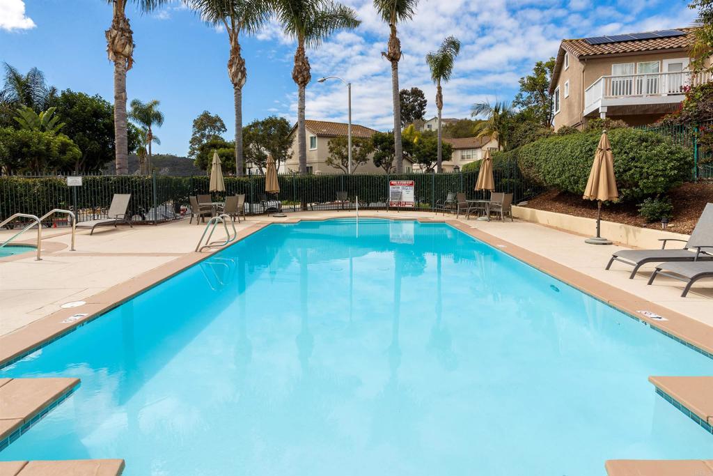 7159 Tanager Drive Carlsbad, CA 92011 - Photo 52 of 68 a swimming pool with outdoor seating and yard