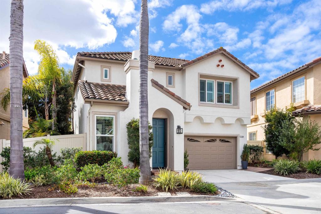 7159 Tanager Drive Carlsbad, CA 92011 - Photo 6 of 68 a front view of a house with a yard and garage